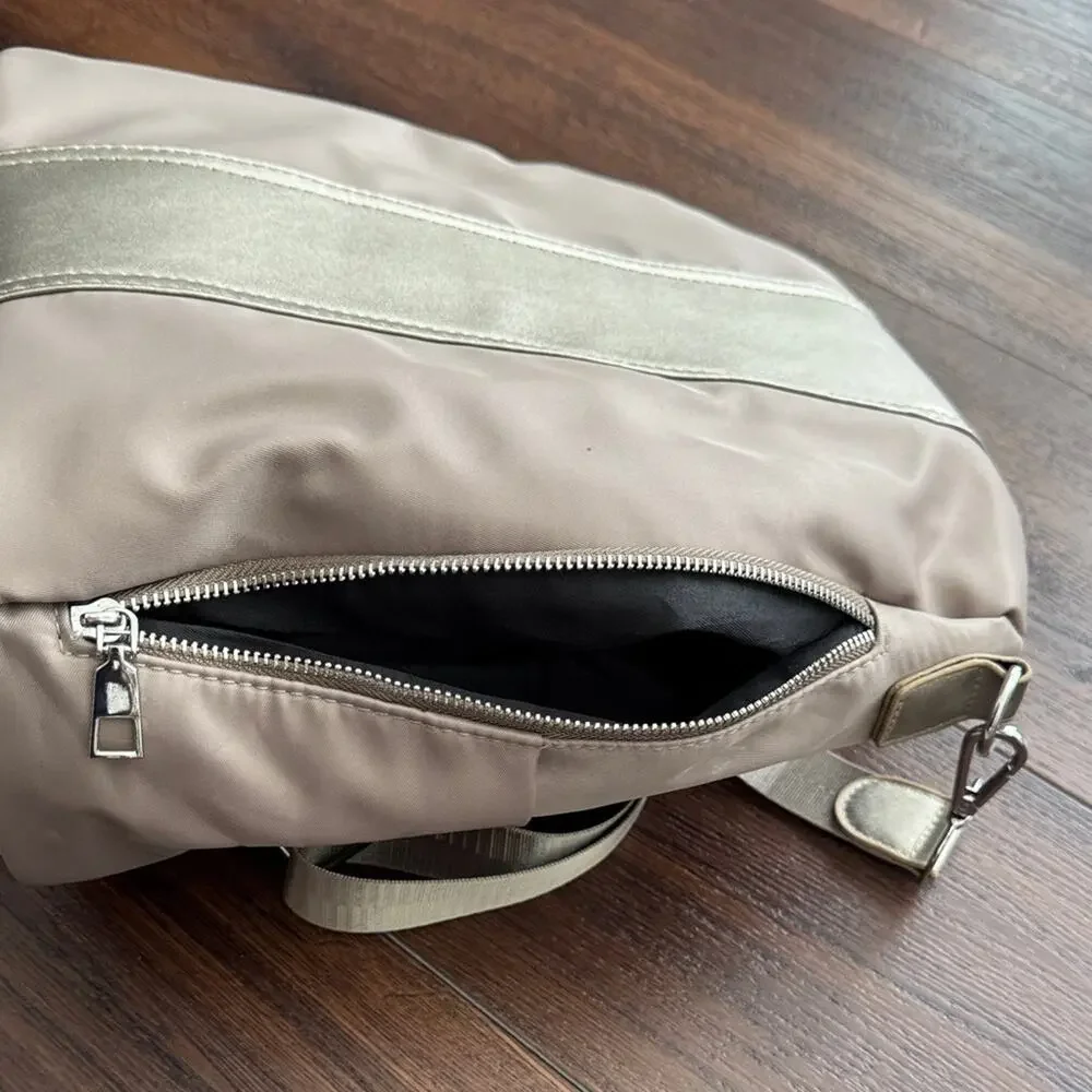 Neutral Taupe Woman’s Backpack with Metallic Accent and many zipper pockets. - Picture 8 of 13